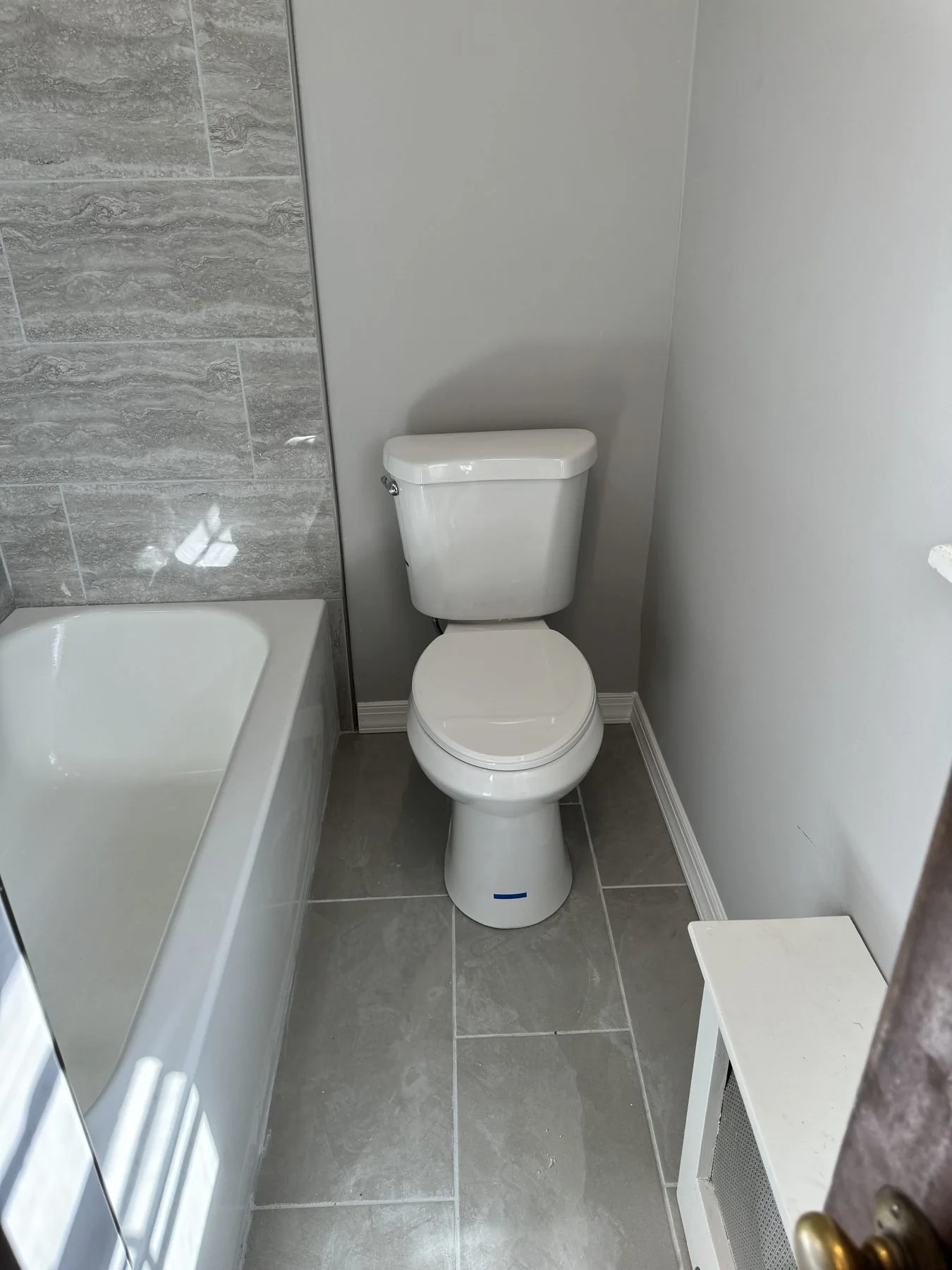 AFTER: new tub, stone-look tile and fixtures